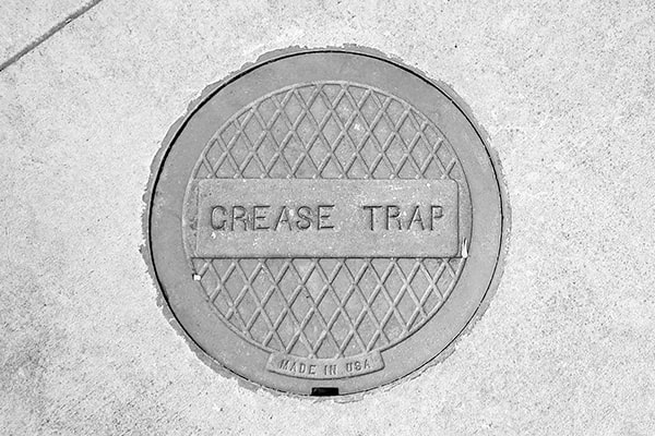 grease trap pumping typically involves suction and removal of grease and solids from the trap